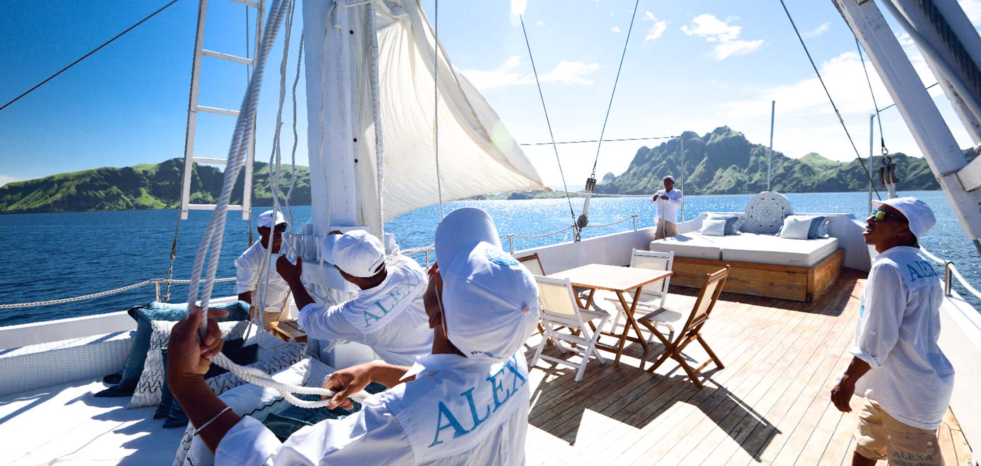 Crew hoisting up the sails of the luxury superyacht Alexa