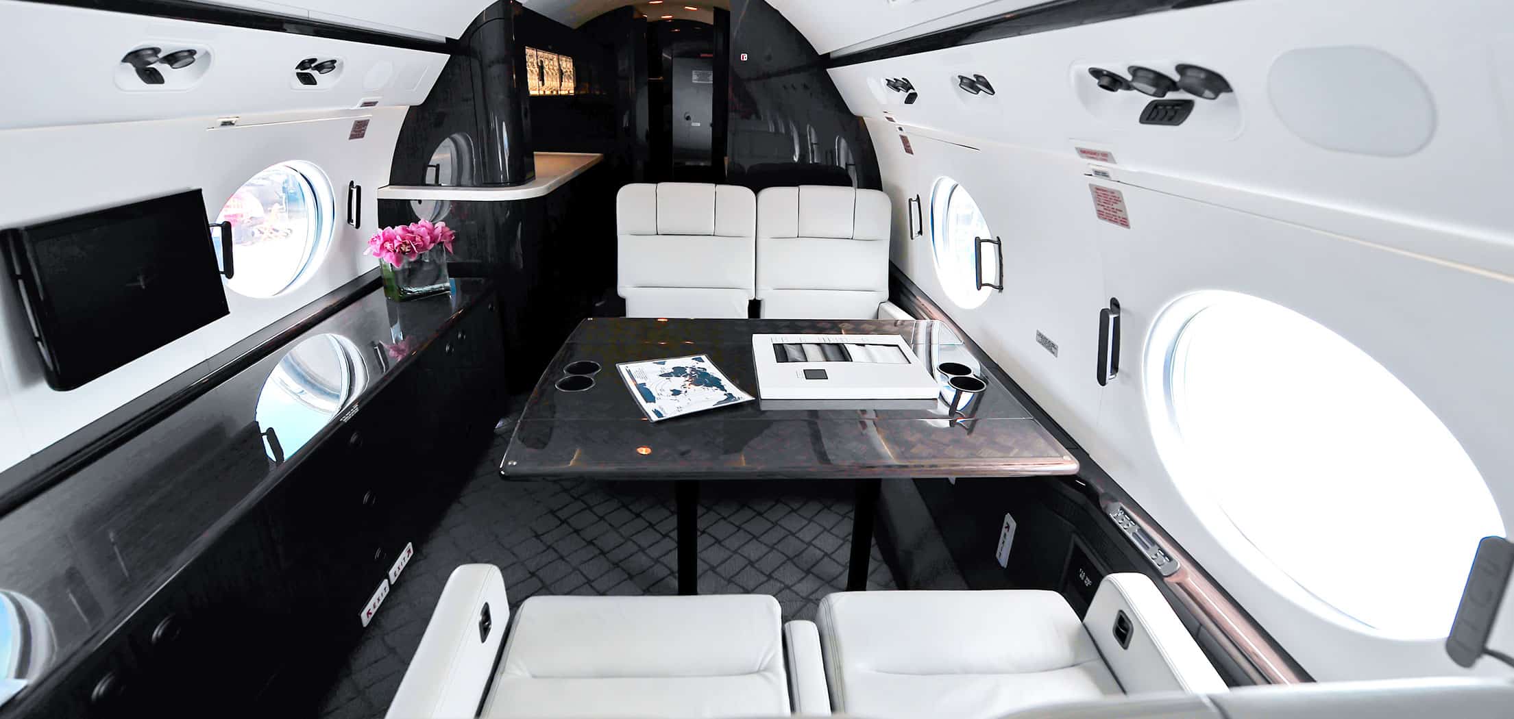 A spacious, black and white interior of a private jet