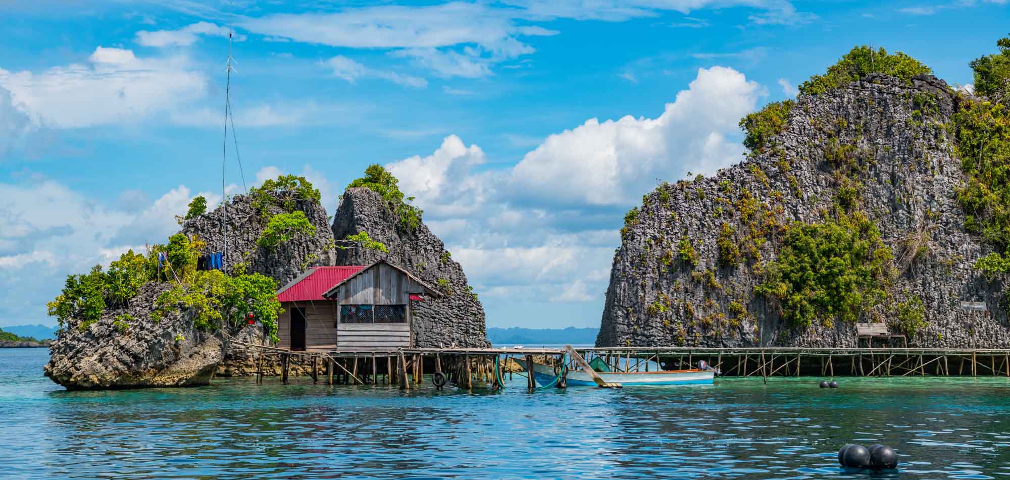 Simple wooden hut at the sea built by natives of West Papua, a region of Indonesia ideal for private yacht charters