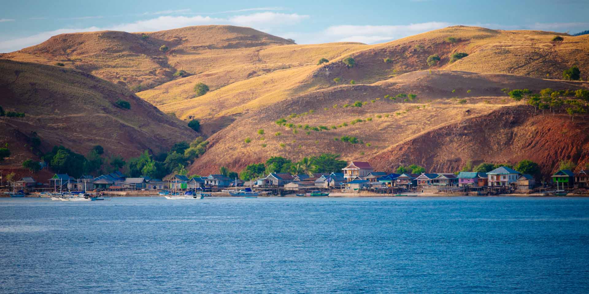 Village on Komodo Islands with golden hour hills in the back