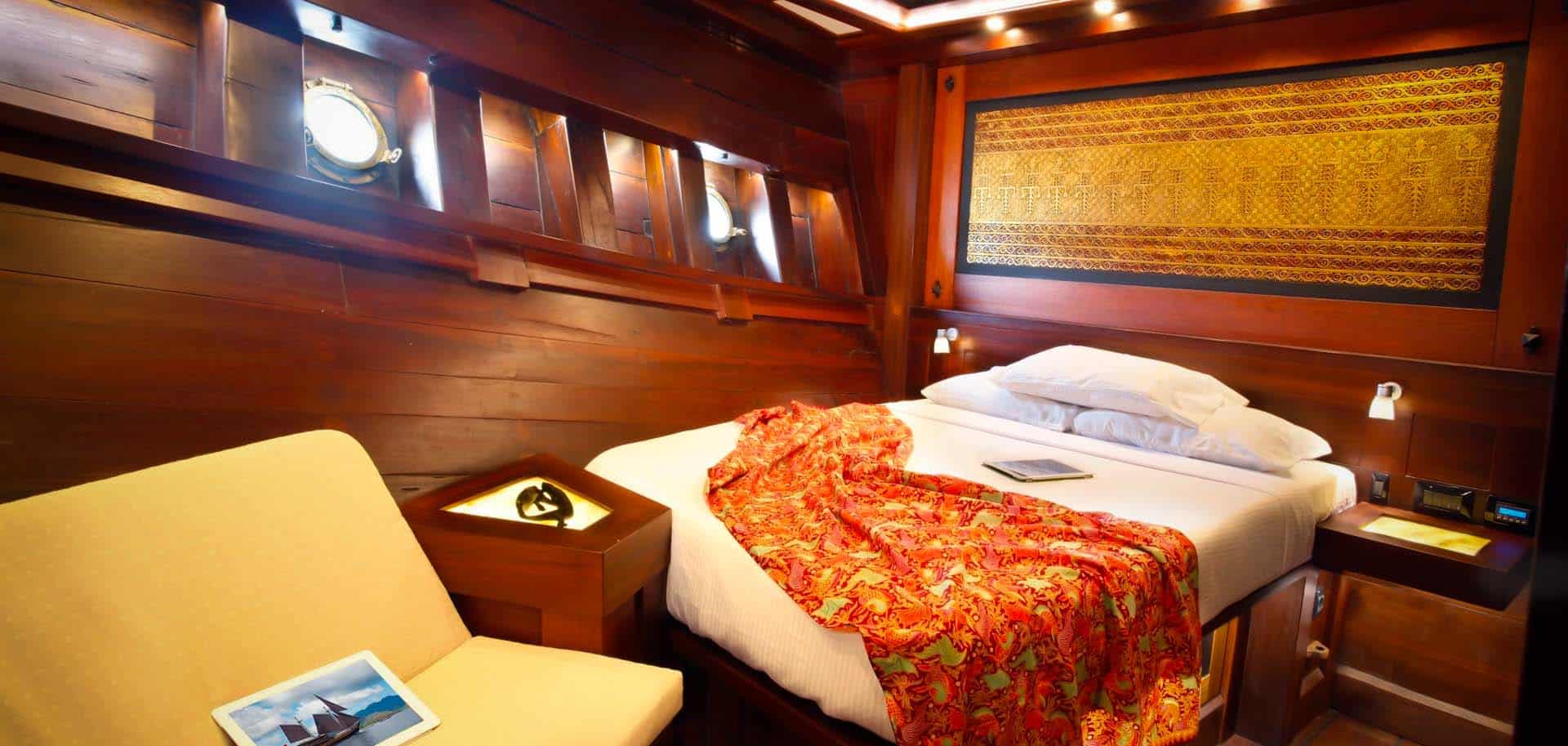 White bed inside a wooden bedroom of Dunia Baru