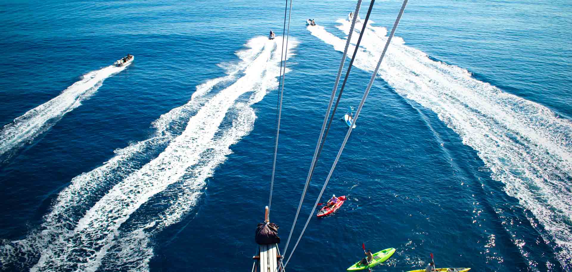 Watersport activitues happening in front of Dunia Baru's wooden bow