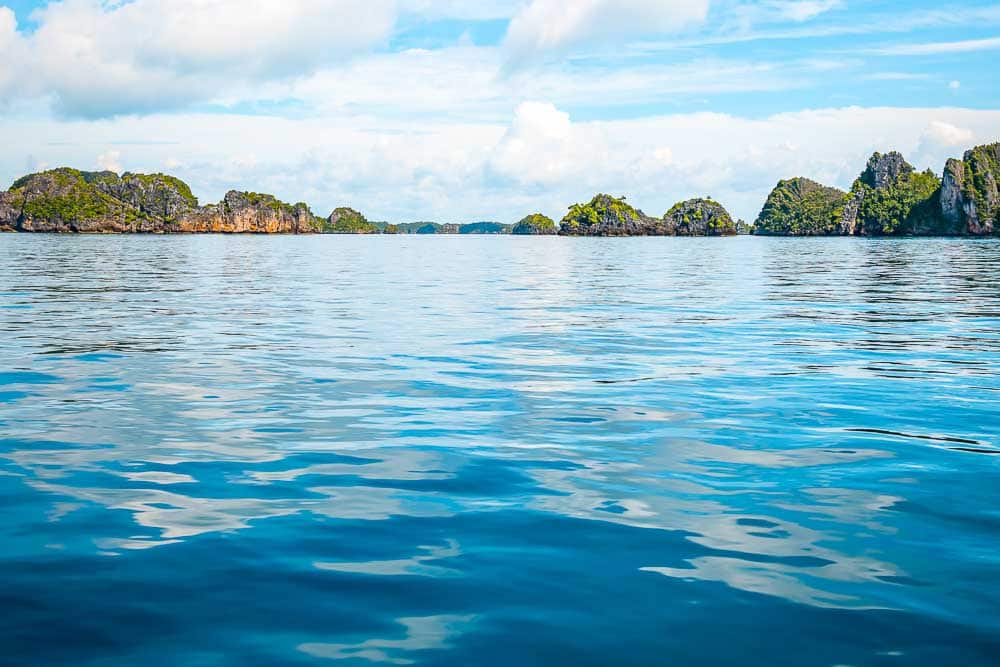 View on Raja Ampat's pristine waters and rocky islets covered with green trees