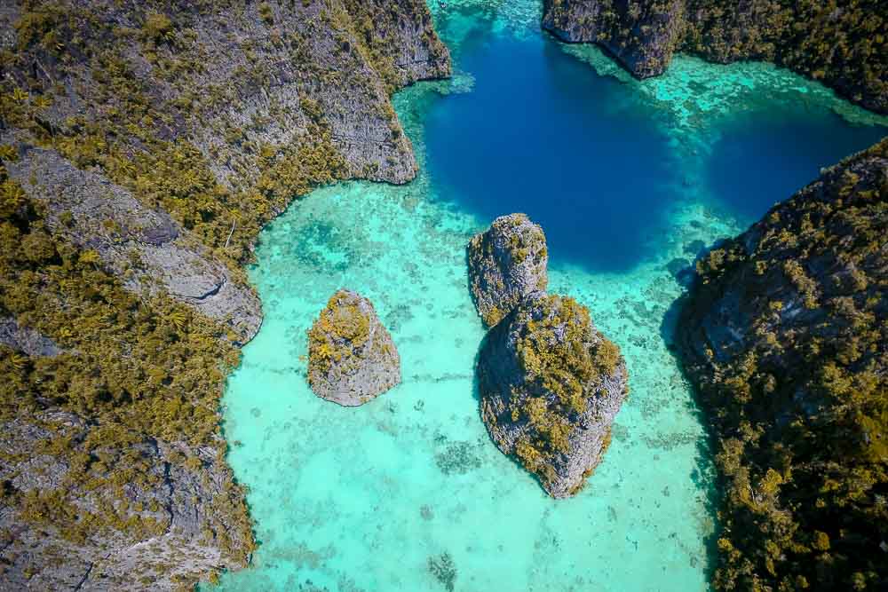 Aerial view on Wayag’s pristine turquoise waters and rocky islands covered with forest
