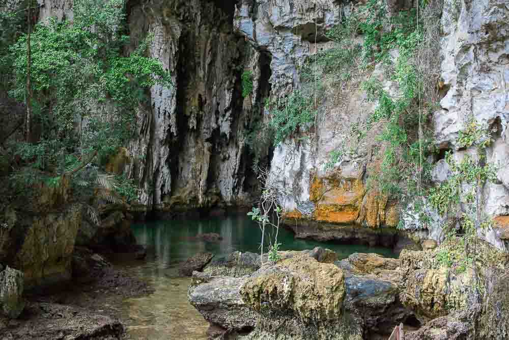 Rocky entrance to a cave hidden in the waters of Misool