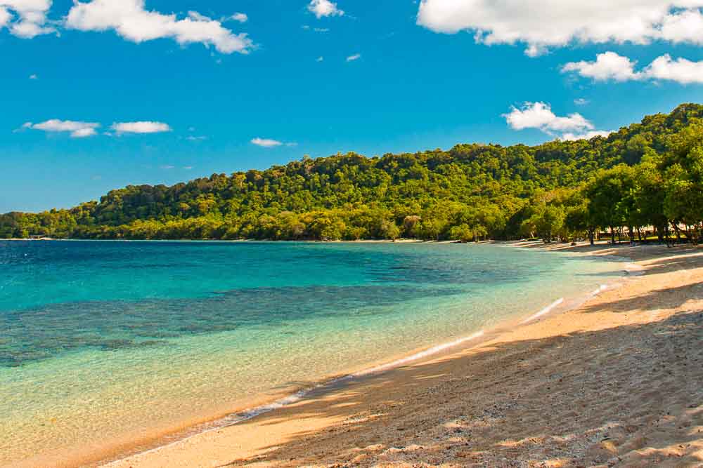 The Amanwana private beach by the bay of the Amanwana luxury resort