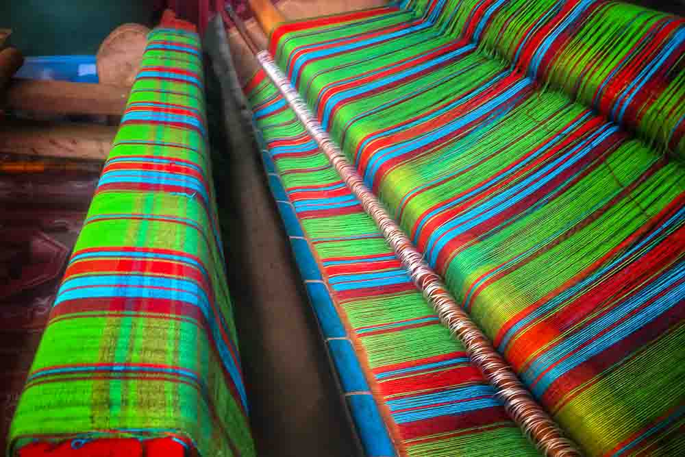 Traditional Indonesian weaving machine with colorful threads