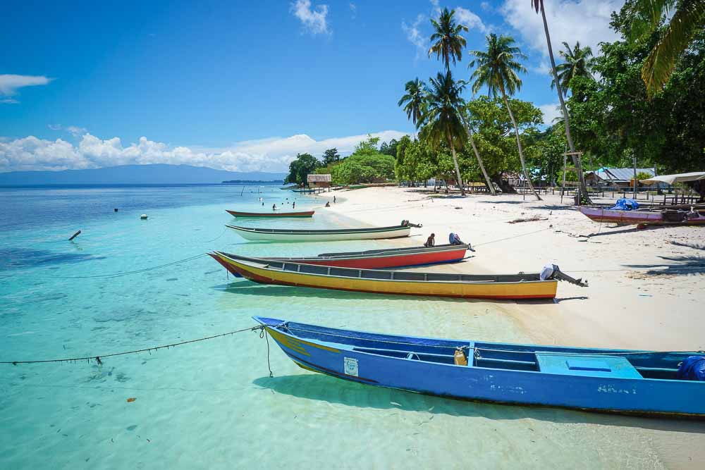 Colorful long fishing boats anchored at the shore in Sauwandarek