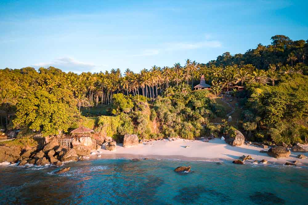 Aerial view on Villa Rahasia in Nihi luxury resort, with anearby private white sand beach and pristine waters