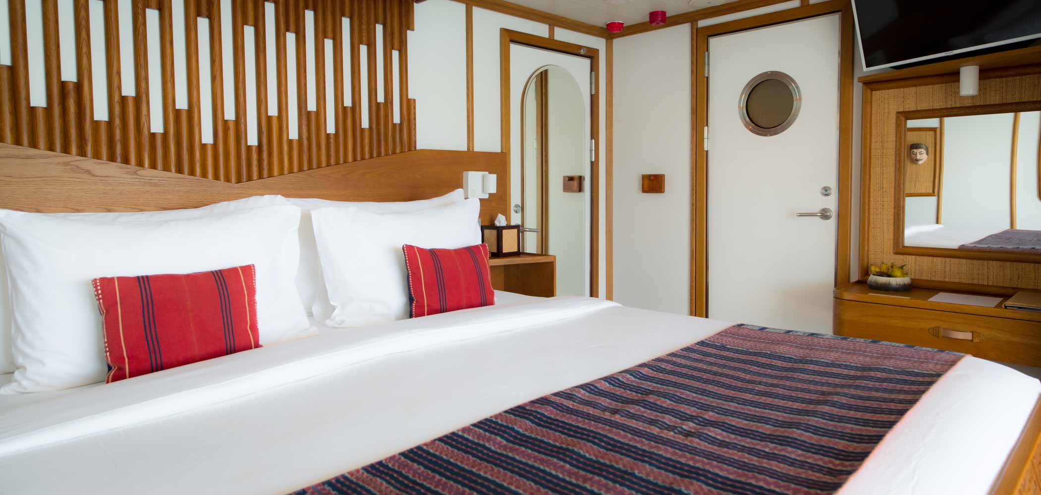 White bed inside the interior luxurious bedroom of Kudanil Explorer