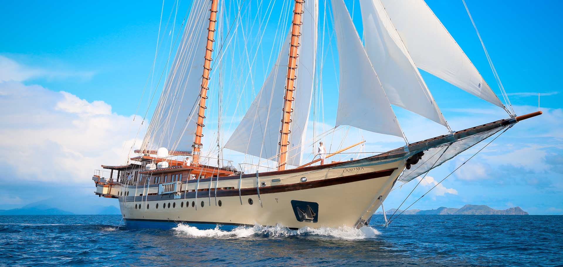 Lamima superyacht for charter with her sails up, cruising through the the blue waters of Indonesia